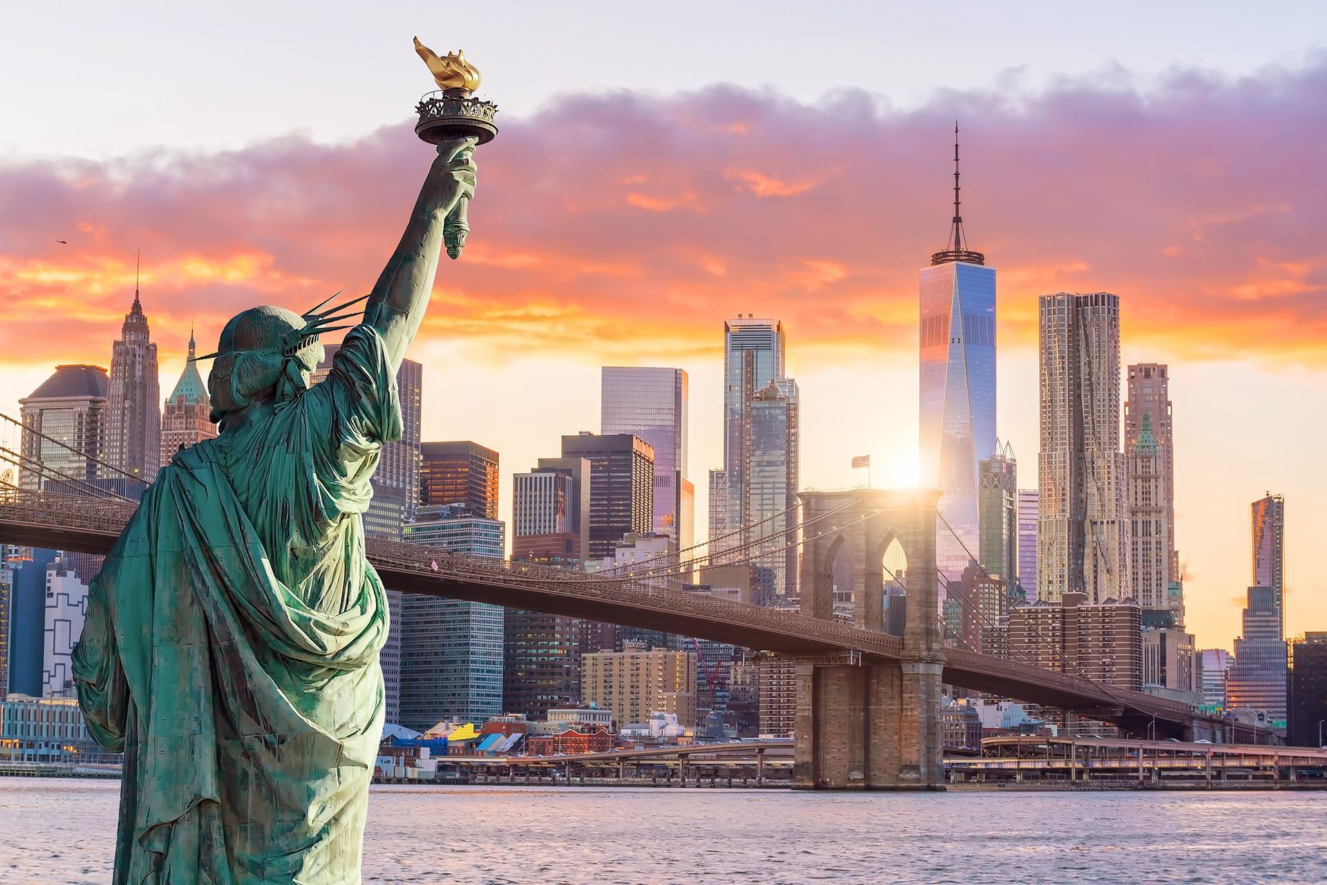 Statue Liberty and  New York city skyline at sunset,  in United States