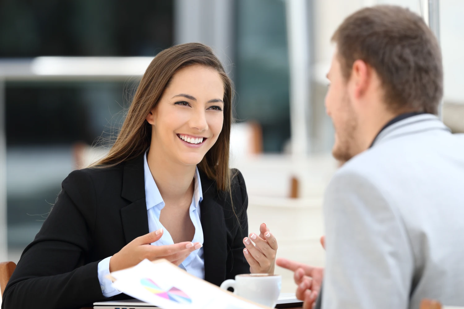 Two happy executives meeting in a restaurant and having a business conversation