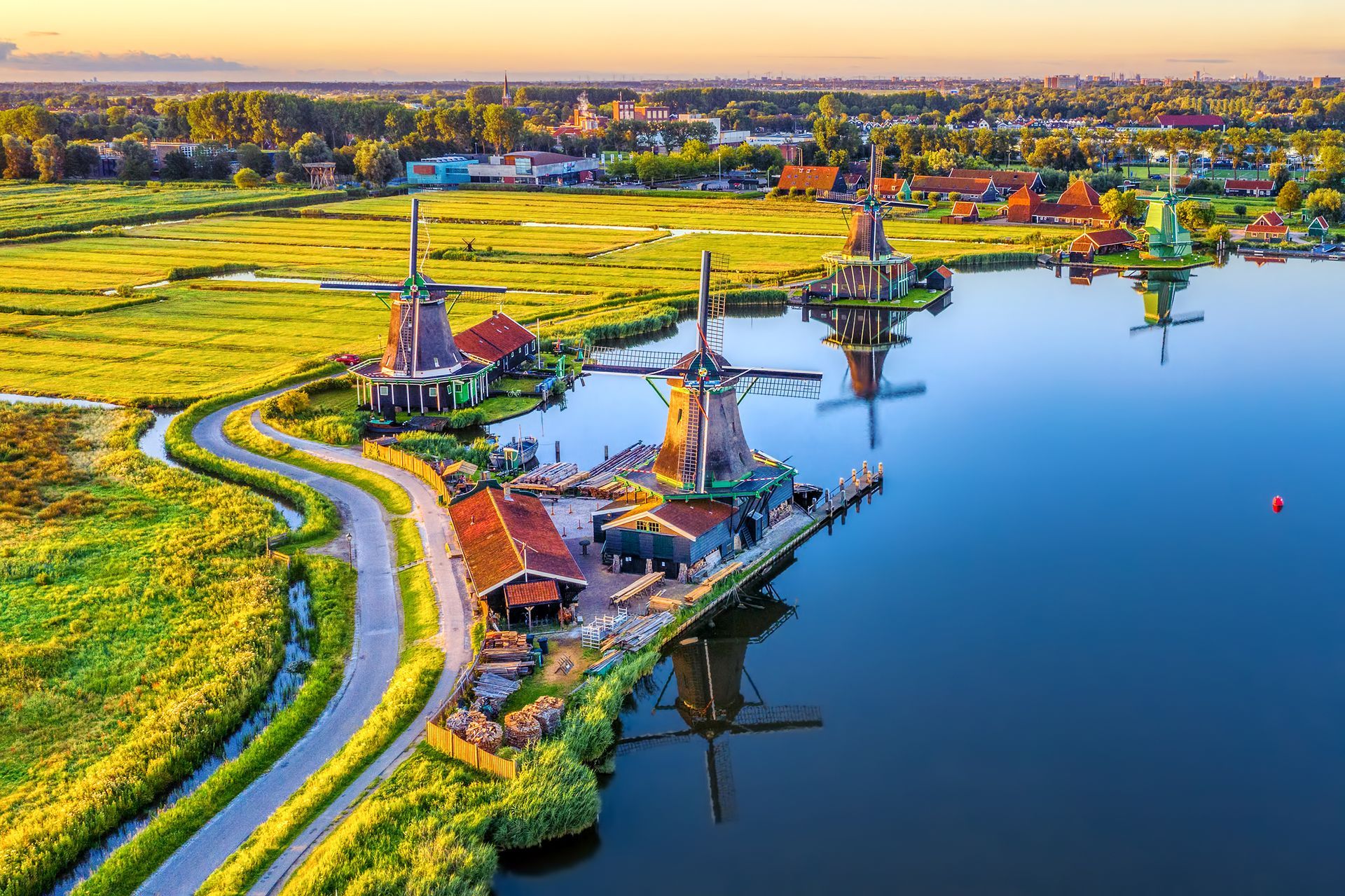 Zaanse Schans windmills park and fields landscape in Zaandam near Amsterdam, North Holland, Netherlands, aerial view in sunrise light